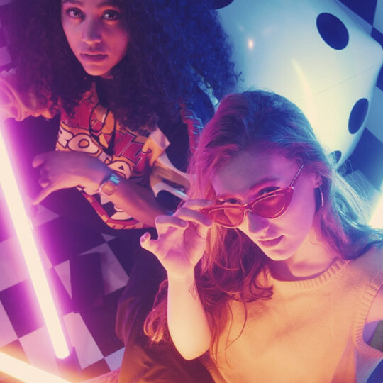 urban-girls-between-bars-of-colored-light
